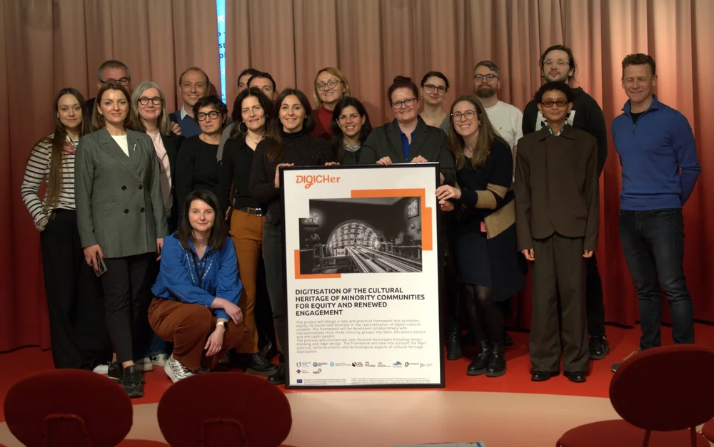 The DIGICHer consortium in The Hague, holding the project poster
